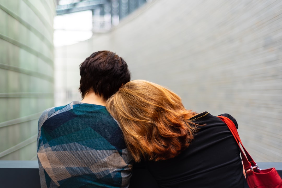 women rests her head on another persons shoulder mental heath LGBTQ+